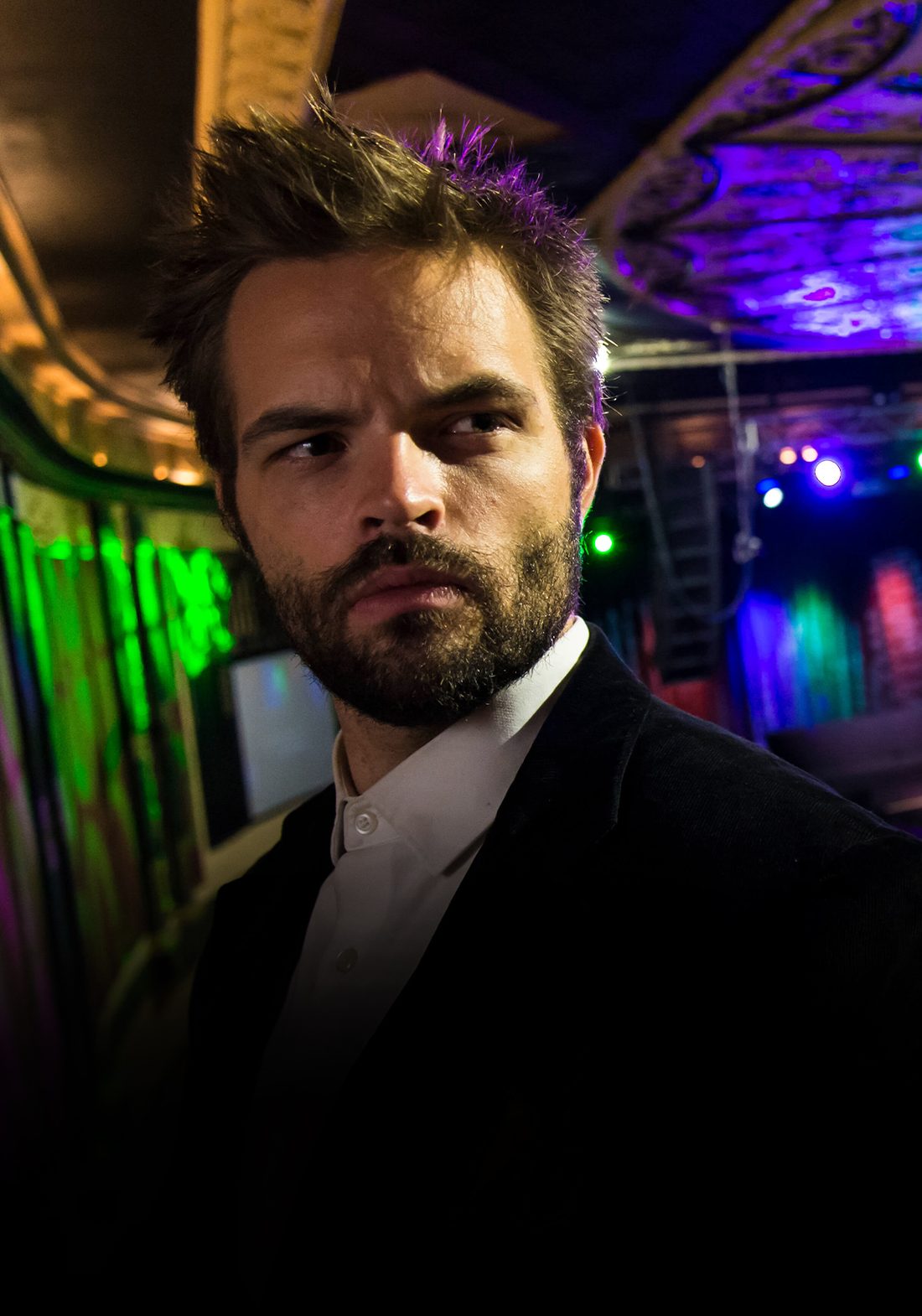 Performer under neon stage lighting — The Mindreader
